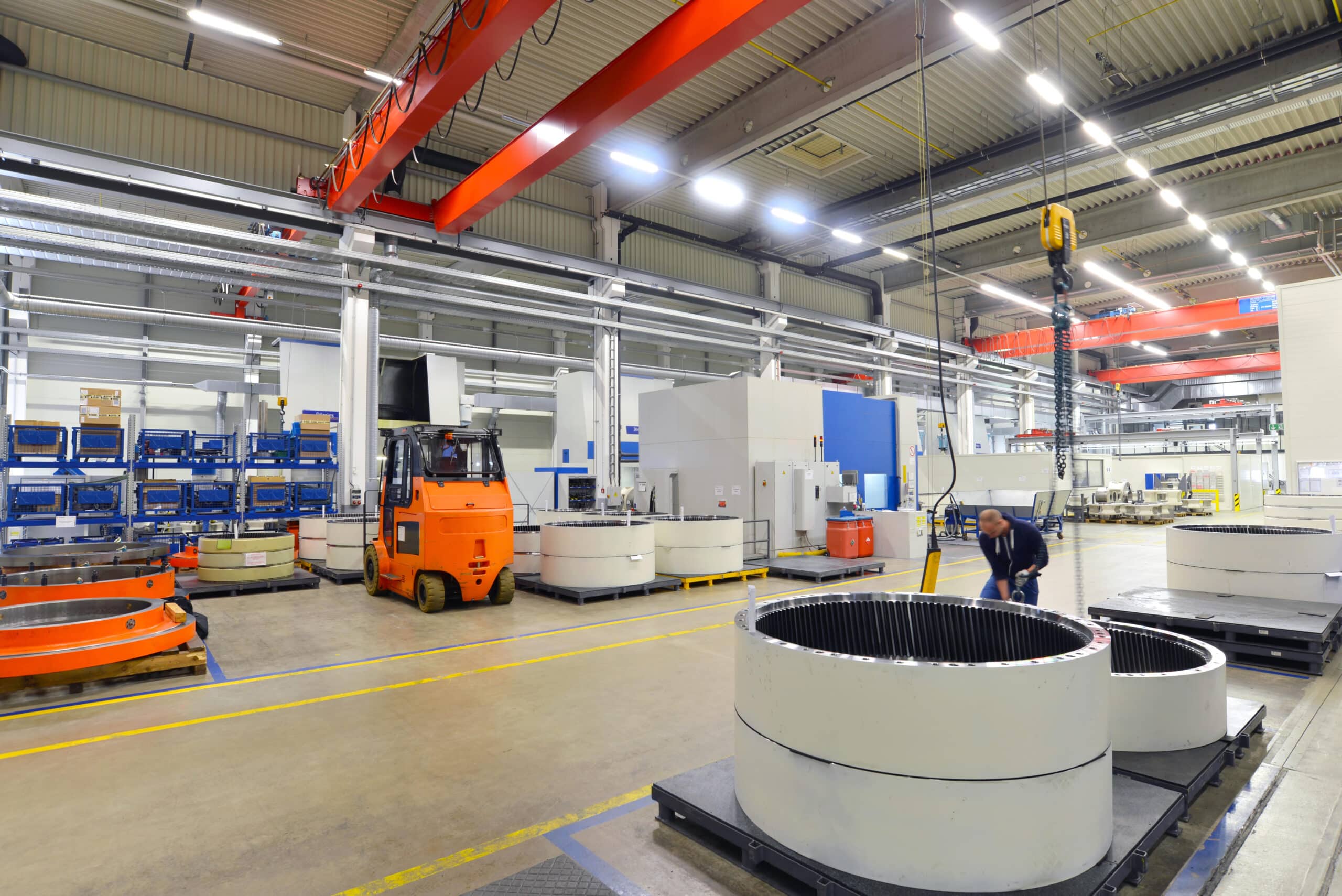 Factory of modern mechanical engineering - production of gearboxes for wind turbines - worker at cnc milling machine